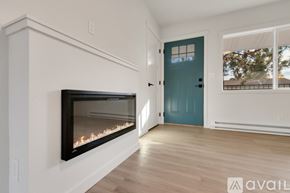 Coeur D'alene apartment for rent - A modern room with a fireplace and a blue door.