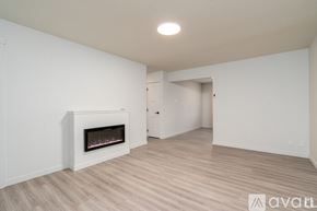 Coeur D'alene apartment for rent - A spacious room with a fireplace and wooden flooring.