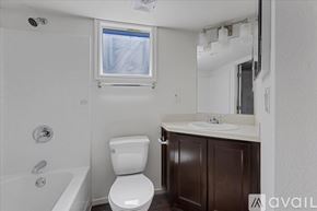 Barstow apartment for rent - A white toilet sits in a bathroom next to a bathtub.