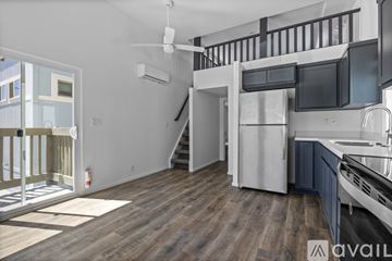 Barstow apartment for rent - A kitchen with a refrigerator, microwave, and stove top oven.