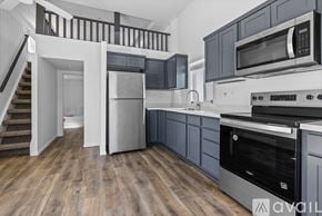 Barstow apartment for rent - A room with a carpeted floor and a staircase with wooden railings.