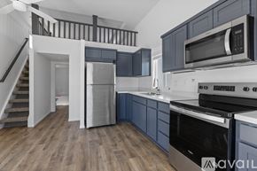 Barstow apartment for rent - A room with a carpeted floor and a staircase with wooden railings.