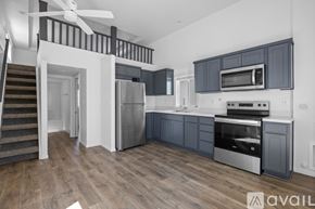 Barstow apartment for rent - A modern kitchen with a stainless steel refrigerator and dark wood cabinets.