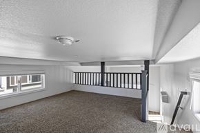 Barstow apartment for rent - A white toilet sits in a bathroom with a white tub and brown cabinet.