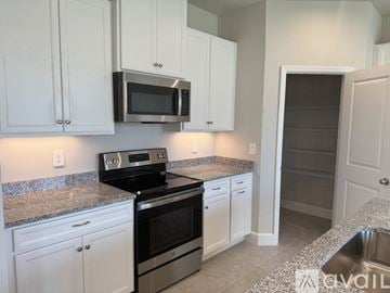 Lakewood Ranch house for rent - A kitchen with white cabinets and a granite countertop.