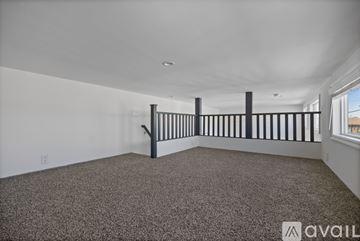 Barstow apartment for rent - A modern kitchen with a stainless steel refrigerator and dark wood cabinets.