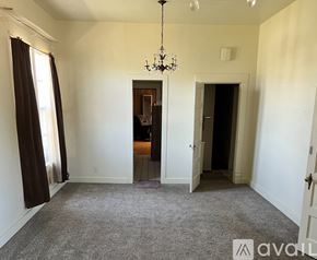 Amarillo house for rent - A room with a chandelier and a carpeted floor.