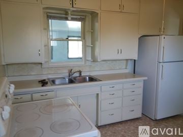 Le Sueur apartment for rent - A kitchen with white cabinets and a white stove top oven.