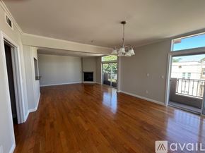 Los Angeles apartment for rent - A spacious room with wooden floors and a large window.