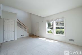 Mountville townhouse for rent - A spacious room with a staircase and a window overlooking a parking lot.