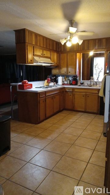 Hempstead house for rent - A kitchen with wooden cabinets and a tiled floor.