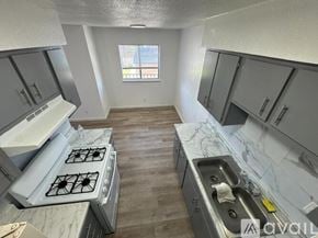Fort Stockton apartment for rent - A kitchen with a stove, sink, and cabinets.