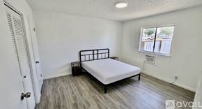 Fort Stockton apartment for rent - A bedroom with a bed, nightstand, and window.