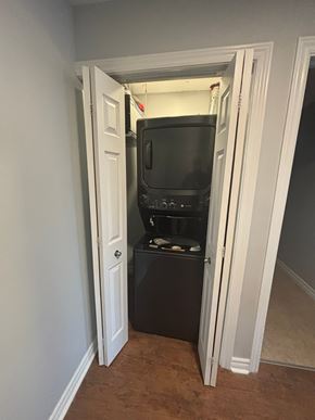 Dartmouth apartment for rent - A black microwave and oven are installed in a cabinet under a door.