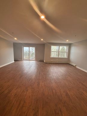 Dartmouth apartment for rent - A room with wooden floors and two windows.