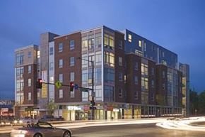 Denver apartment for rent - A multi-story building with a parking lot in front of it.