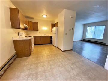 La Crosse townhouse for rent - an empty kitchen with a refrigerator and a sink