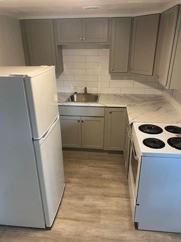 Halifax apartment for rent - A white refrigerator is in a kitchen with a white tiled backsplash.