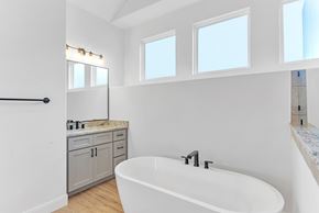 Horseshoe Bay house for rent - A white bathroom with a tub, sink, and a vanity.