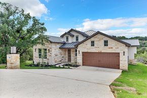 Horseshoe Bay house for rent - A house with a brown garage door and a stone exterior.