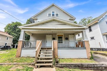 Akron apartment for rent - A house with a grey roof and a white front porch.