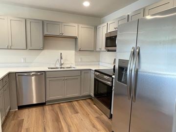 Belgium apartment for rent - A kitchen with a refrigerator on the right.