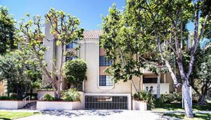Los Angeles apartment for rent - A house with a driveway and trees in front of it.
