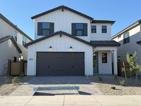 Chandler house for rent - A modern house with a white exterior and a black garage door.