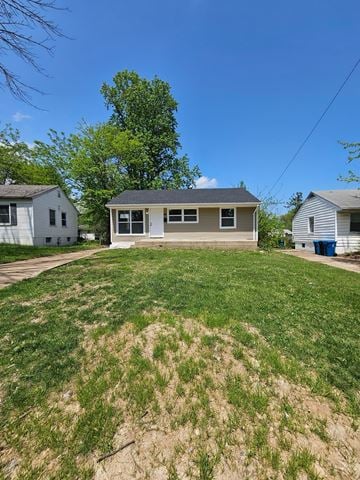 St Louis house for rent - A house with a brown roof and a white garage door is in the background.