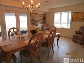 Revere house for rent - A dining room with a wooden table and chairs.