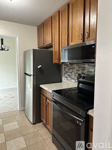 Spring Lake house for rent - A kitchen with brown cabinets and white appliances.