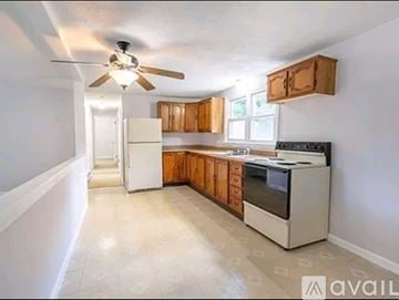 Oxford apartment for rent - A kitchen with white appliances and wooden cabinets.