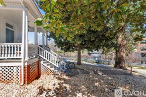Charlottesville house for rent - A bedroom with a bed, nightstand, and a dresser with a mirror above it.