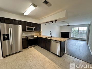 Rockwall condo for rent - A kitchen with a refrigerator, microwave, and sink.