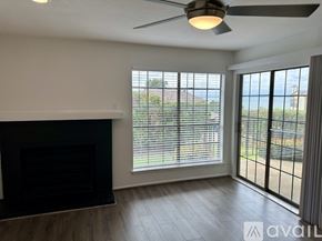 Rockwall condo for rent - A living room with a fireplace and sliding glass doors.