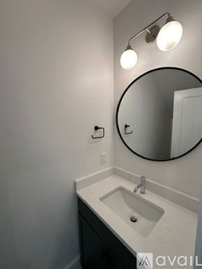 Oklahoma City house for rent - A bathroom with a sink, mirror, and light fixture.
