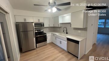 Portage apartment for rent - A kitchen with stainless steel appliances and white cabinets is available for rent.