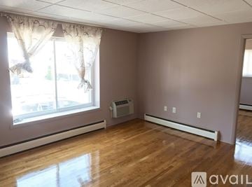 Braintree apartment for rent - A kitchen with white cabinets and a black stove top oven.