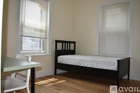Boston apartment for rent - A bedroom with a bed, table and chairs.