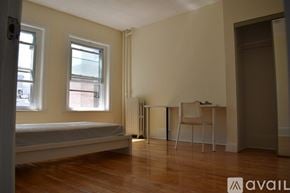 Boston apartment for rent - A room with a bed, desk, and chair.