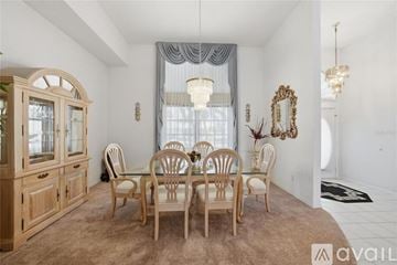 Port Charlotte house for rent - A living room with a red rug and a ceiling fan.