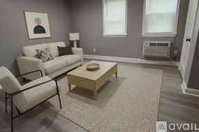 Baltimore apartment for rent - A spacious room with grey walls and a wooden floor.