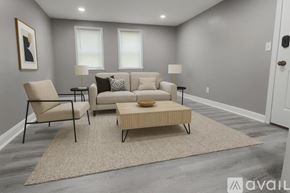 Baltimore apartment for rent - A living room with a beige sofa, two chairs, and a coffee table.