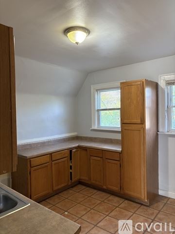 Milwaukee apartment for rent - A kitchen with wooden cabinets and a window.
