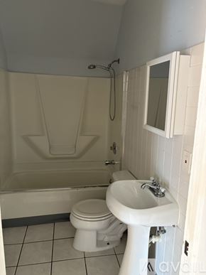 Milwaukee apartment for rent - A white toilet and sink in a small bathroom.