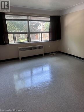 Hamilton apartment for rent - A room with a window and a radiator on the floor.