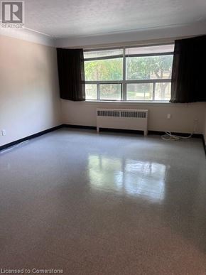 Hamilton apartment for rent - A room with a window and a radiator on the wall.