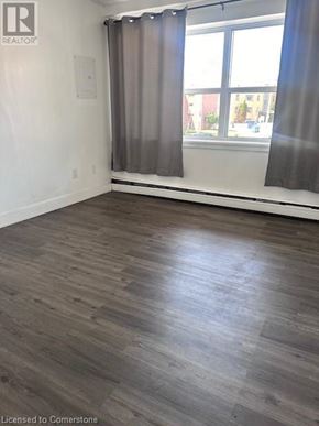 Dundas apartment for rent - A room with a window and curtains.