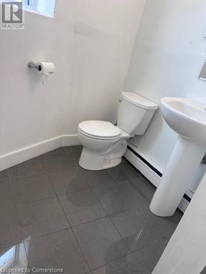 Dundas apartment for rent - A white toilet and sink in a bathroom.