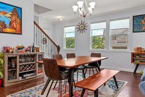Apex house for rent - A dining room with a wooden table and chairs.